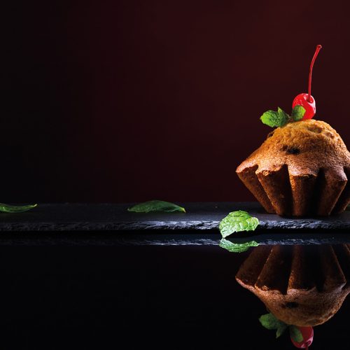 cupcake on black reflective background